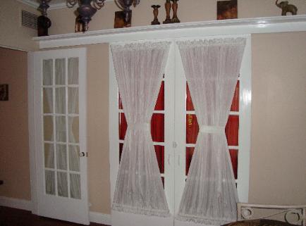 Sliding French Doors lead to Living Room from bedroom/office facing South.
